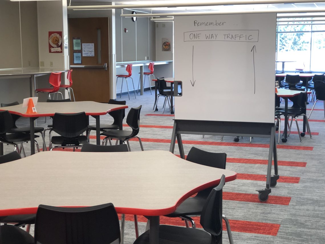 photo of open classroom tables and whiteboard