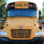Front profile of a yellow bus for Forest Hills Public Schools