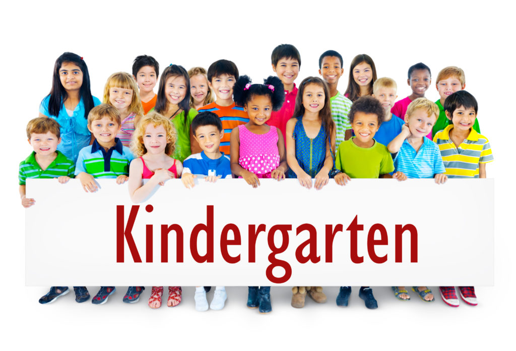kids holding a poster saying kindergarten