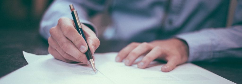 photo of a person signing a document