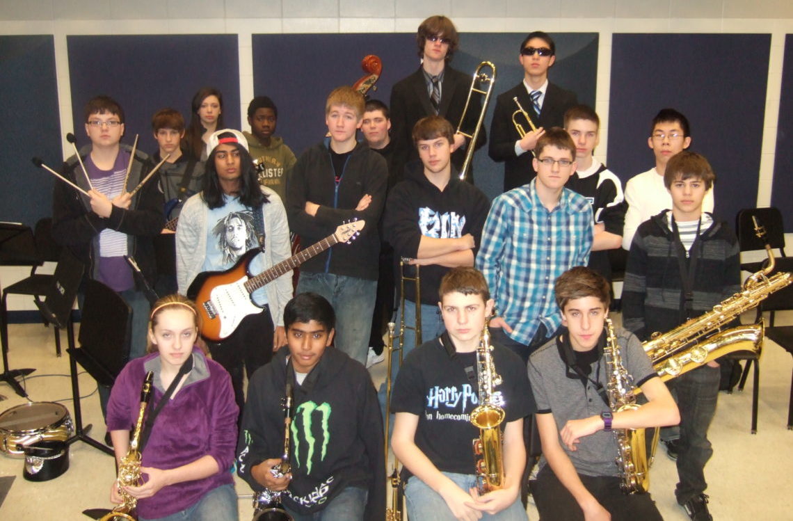 high school jazz band posing with their instruments