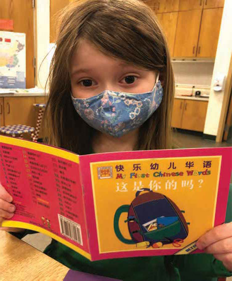 student reading a book in mandarin chinese