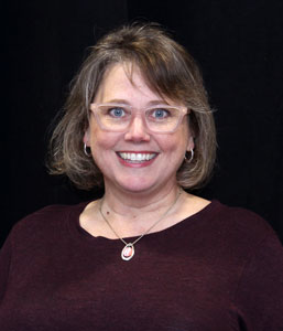 head and shoulder photo of middle aged woman with short hair and glasses