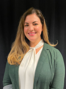 woman with long hair, and a blouse and cardigan