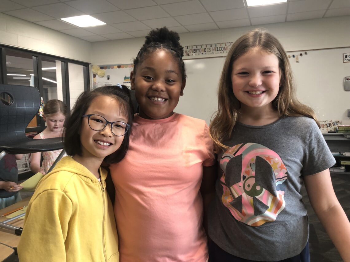 three elementary girls together