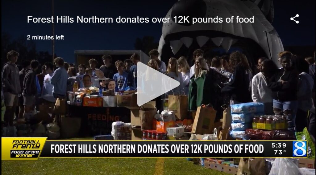 screen shot of football frenzy with students on a football field and lots of donated food