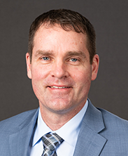 man with light blue suit and tie