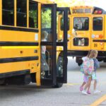 students get off a school bus