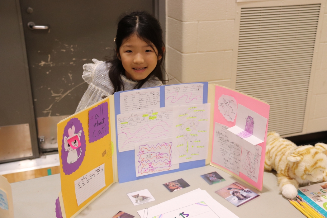 young student showing her her cat presentation