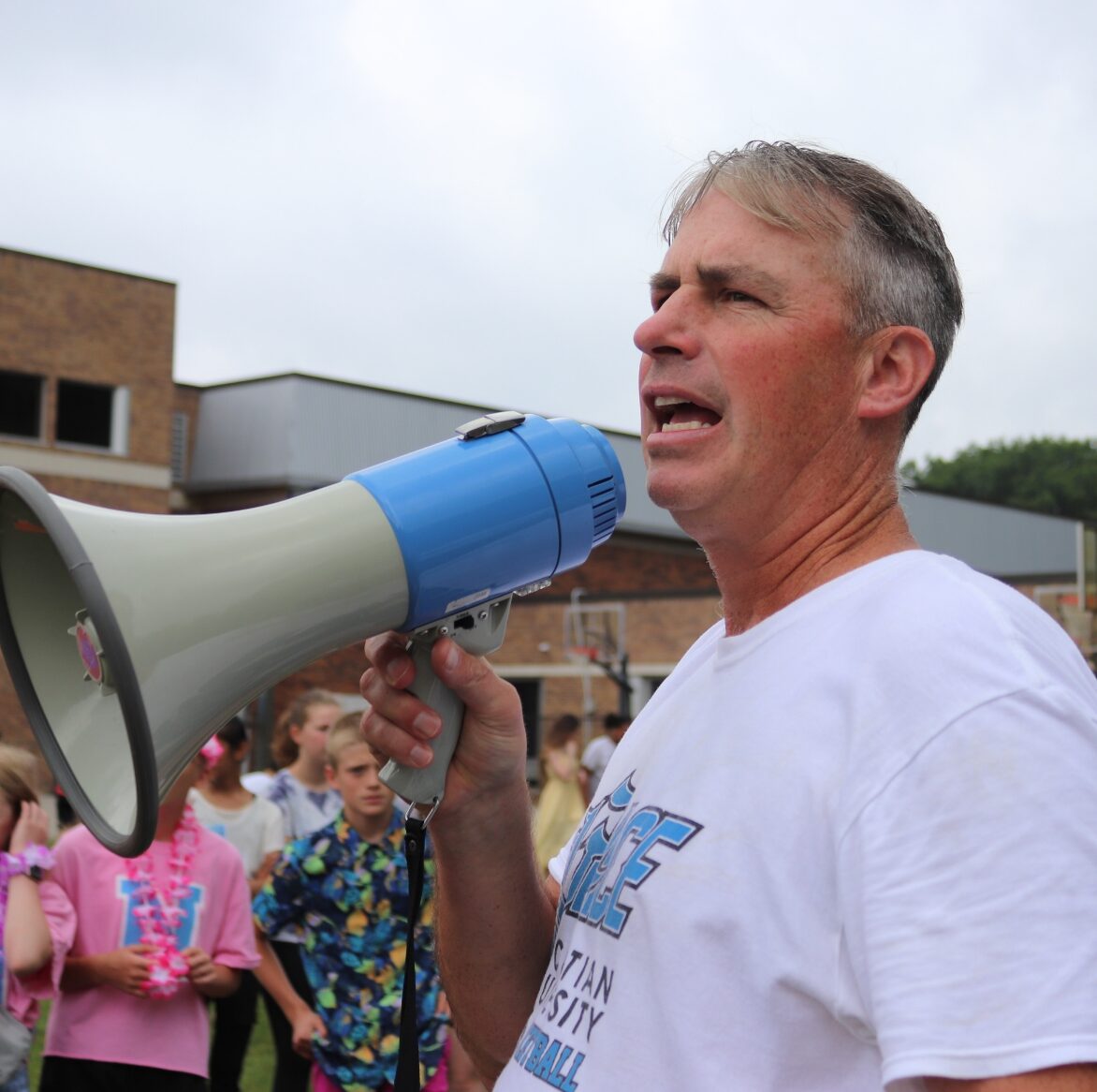 male teacher with a megaphone outside