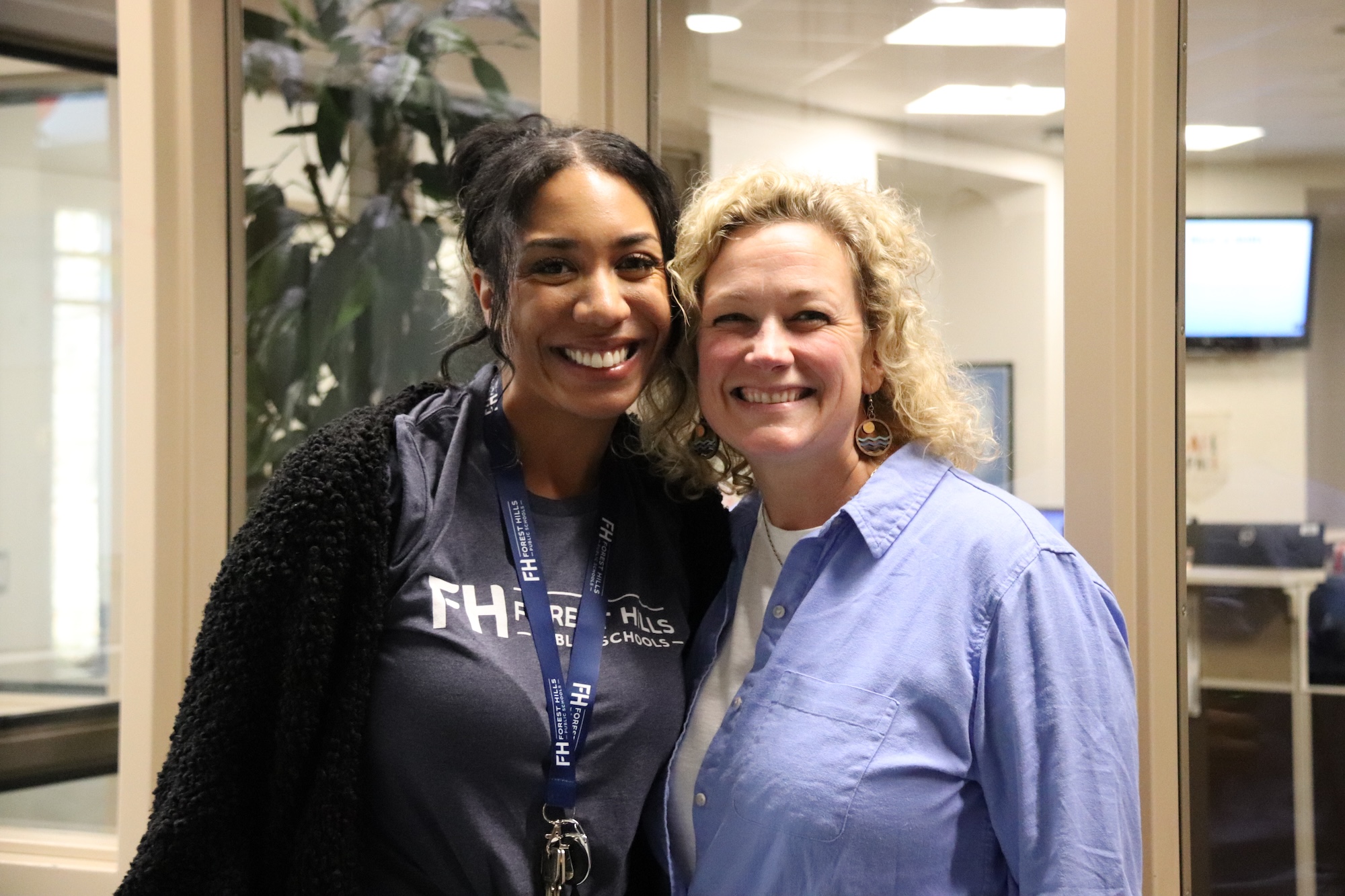 two female staff members smiling for a picture