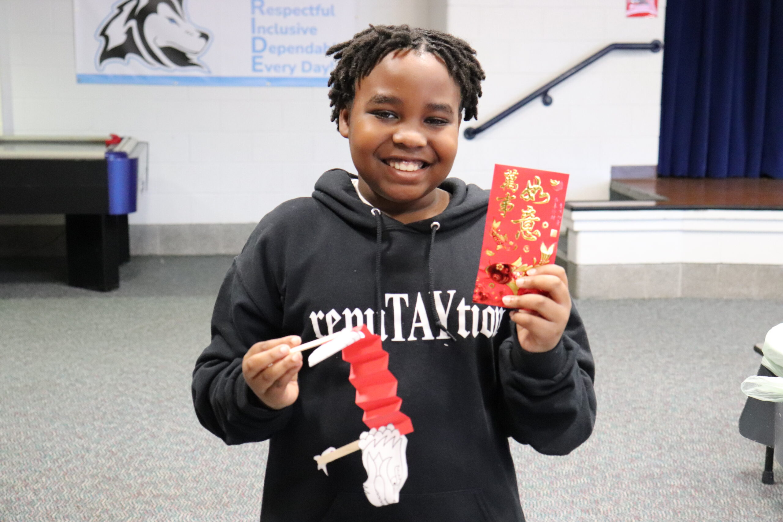 male student showing off his Chinese decorations