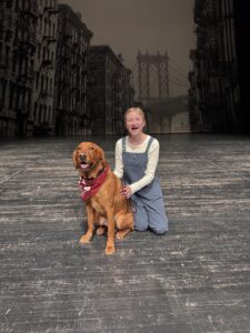 a girl on stage with a dog