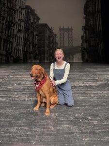 a girl on stage with a dog