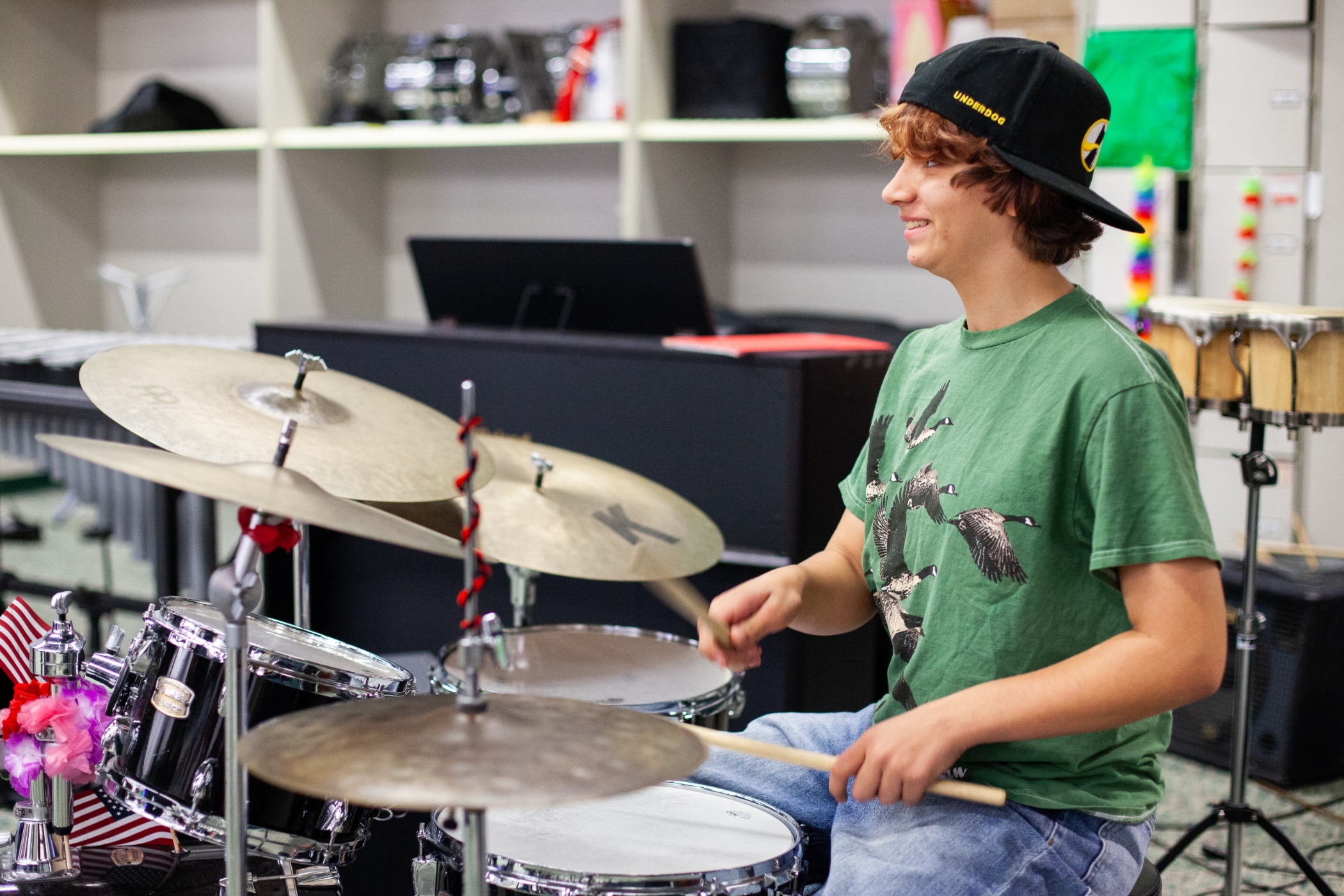 student drummer sitting at his drums