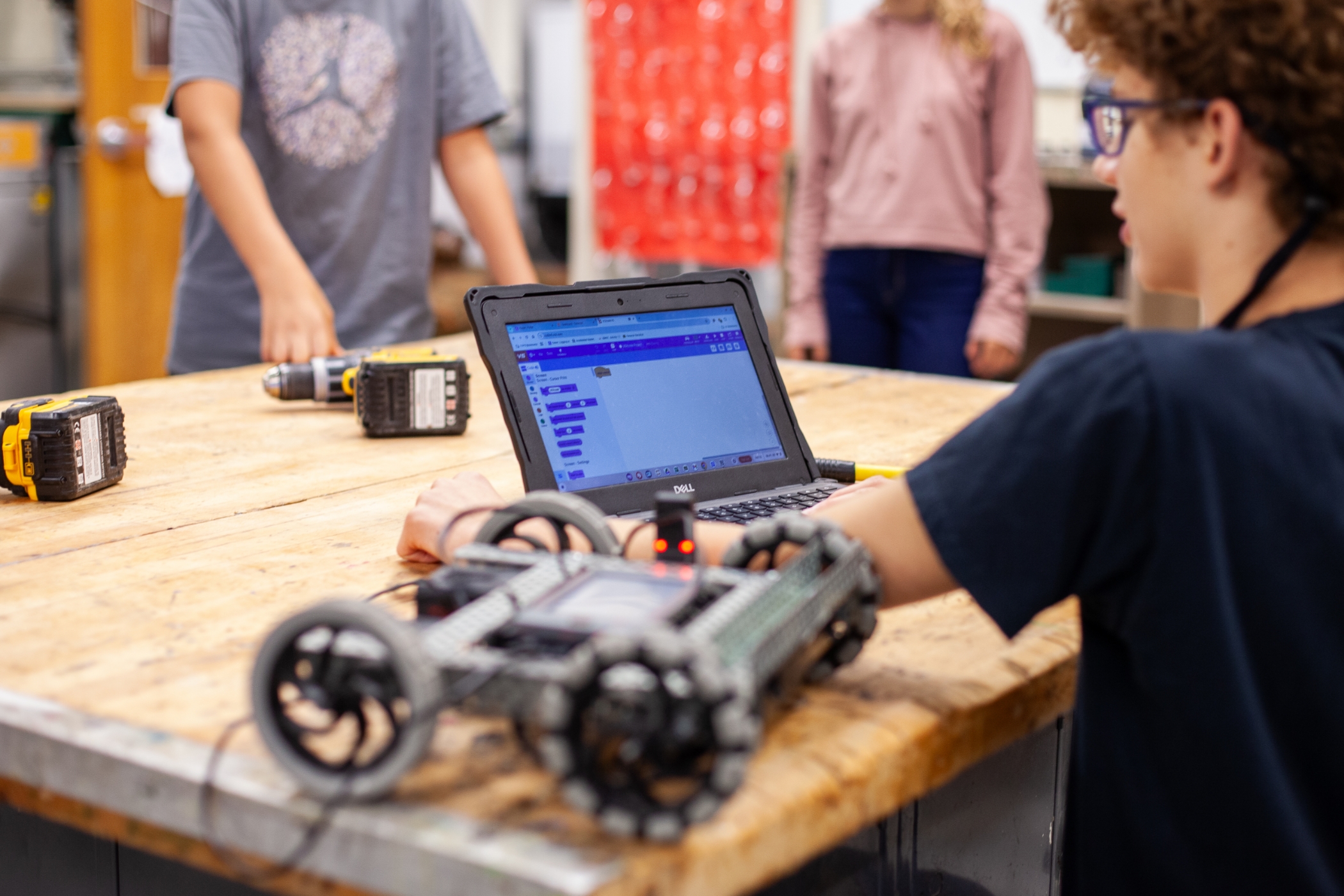 student working on a computer connected to a computer