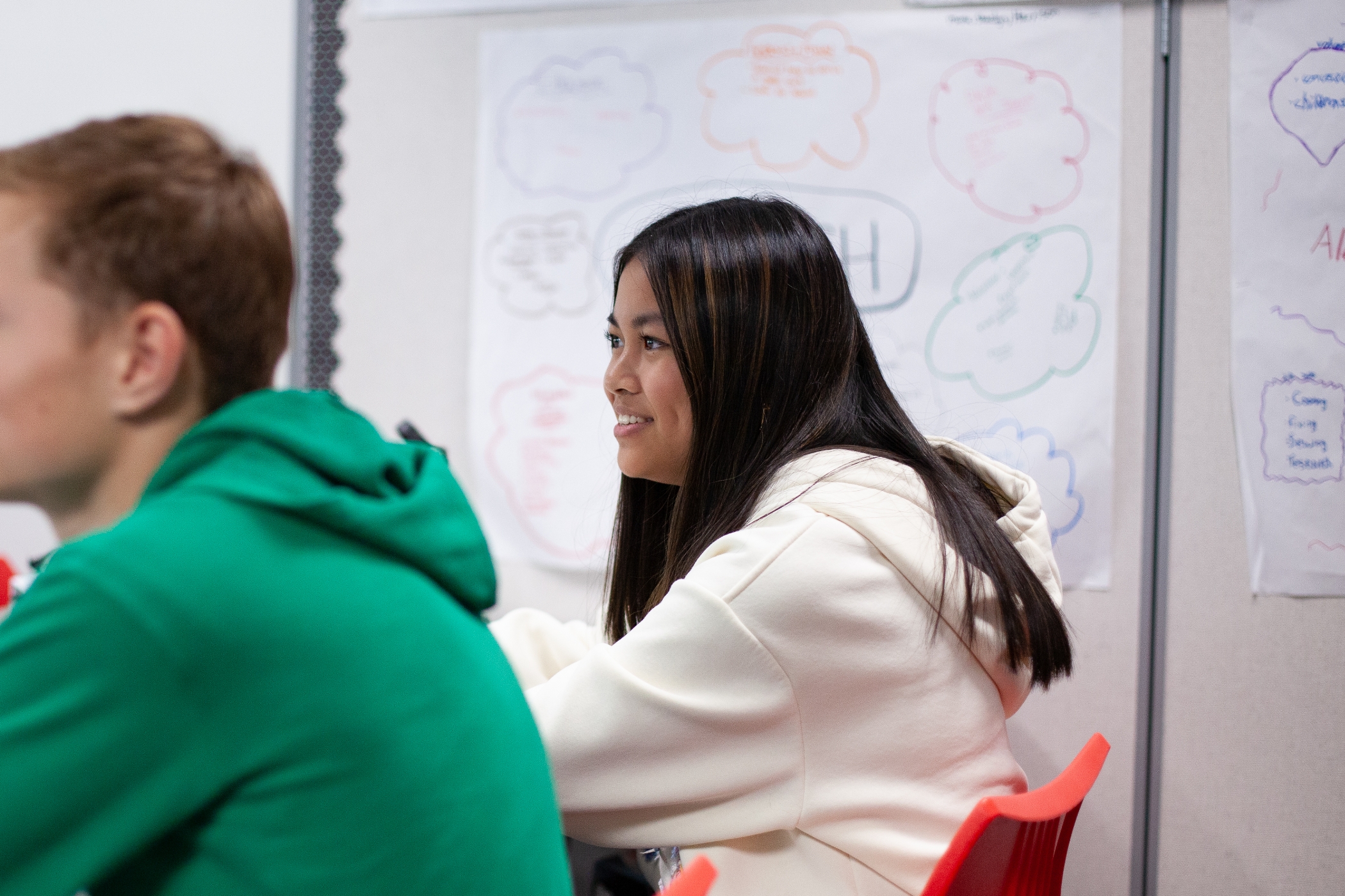 girl sitting in class smiling