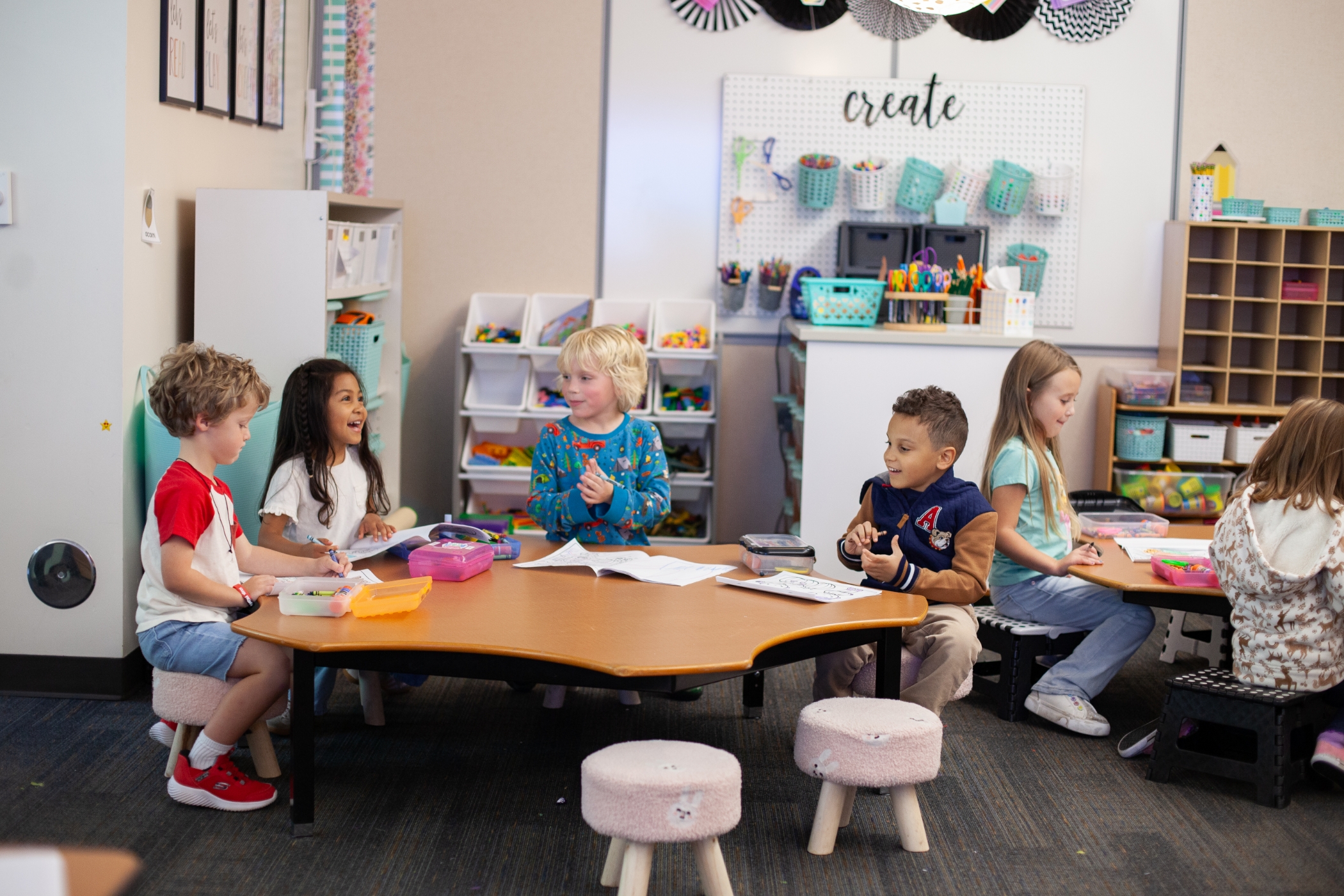 young students sitting around a desk
