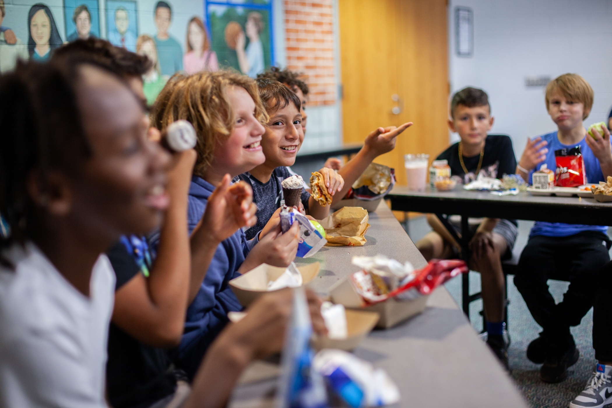 students sitting at table eating ice cream