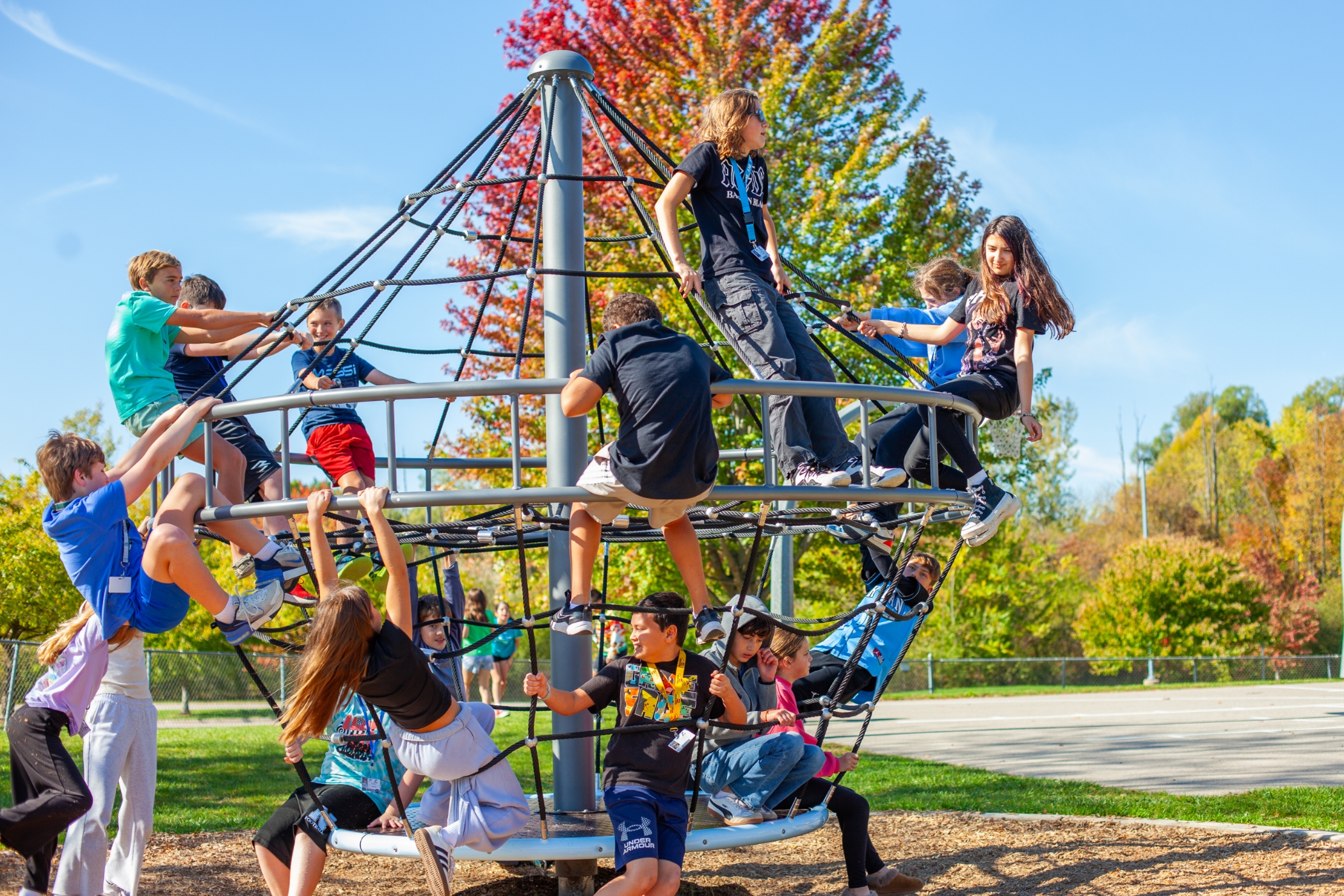 multiple students playing on jungle gym