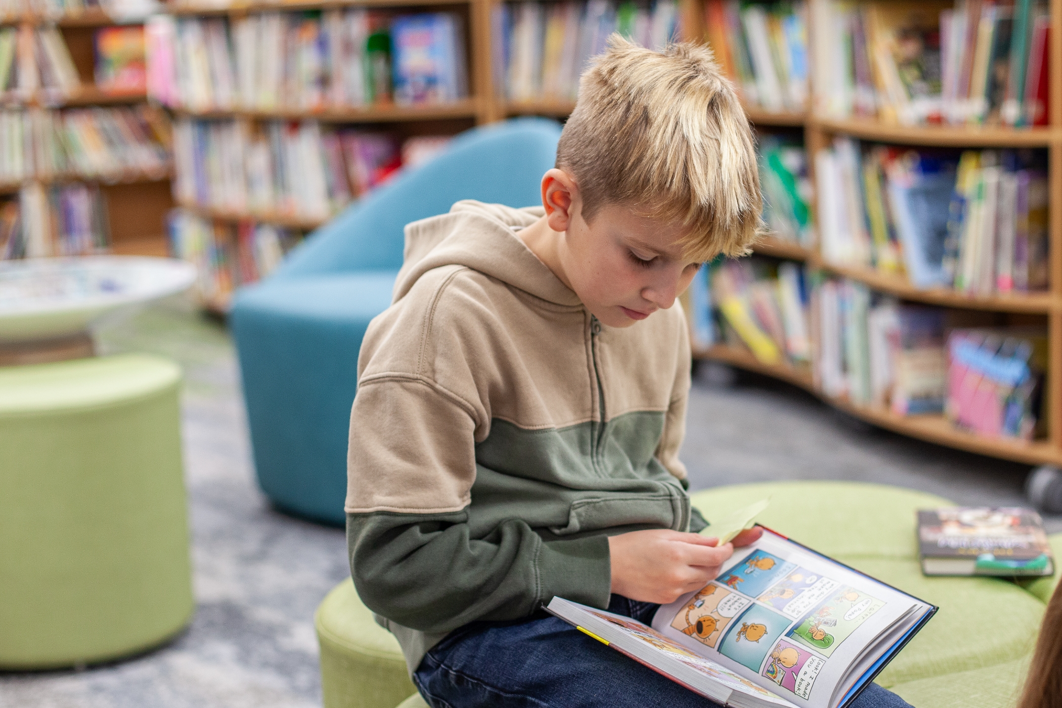 young student reading in a library