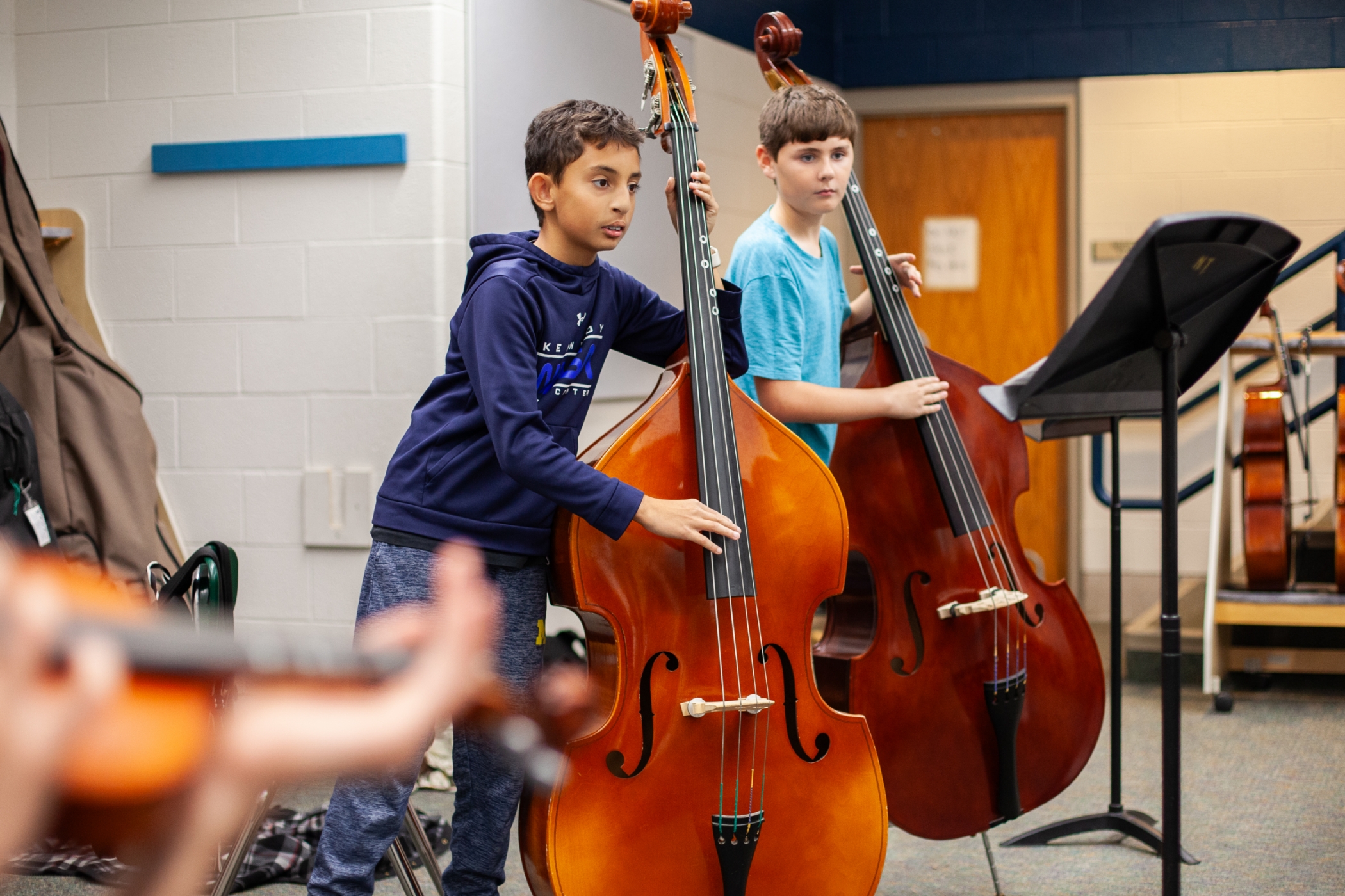 two students playing the cellos