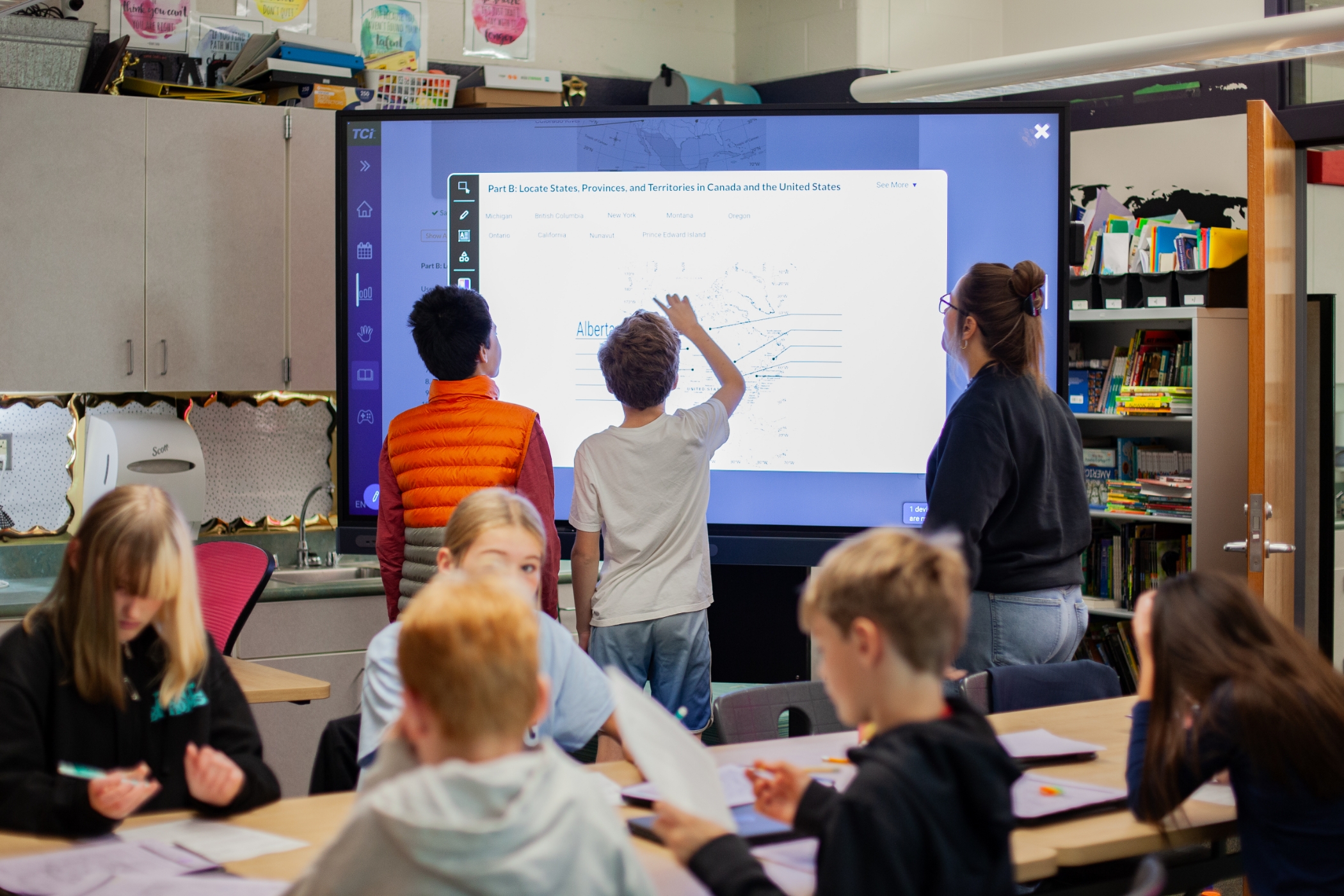students working on a digital whiteboard