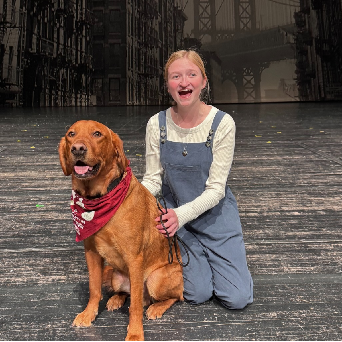 student on stage with a dog while singing