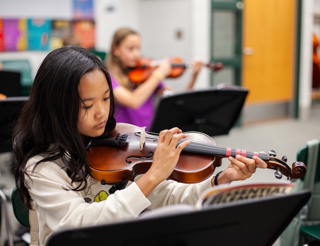 student playing a violin