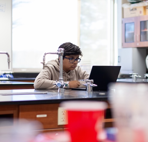 male student working on a computer in a lab