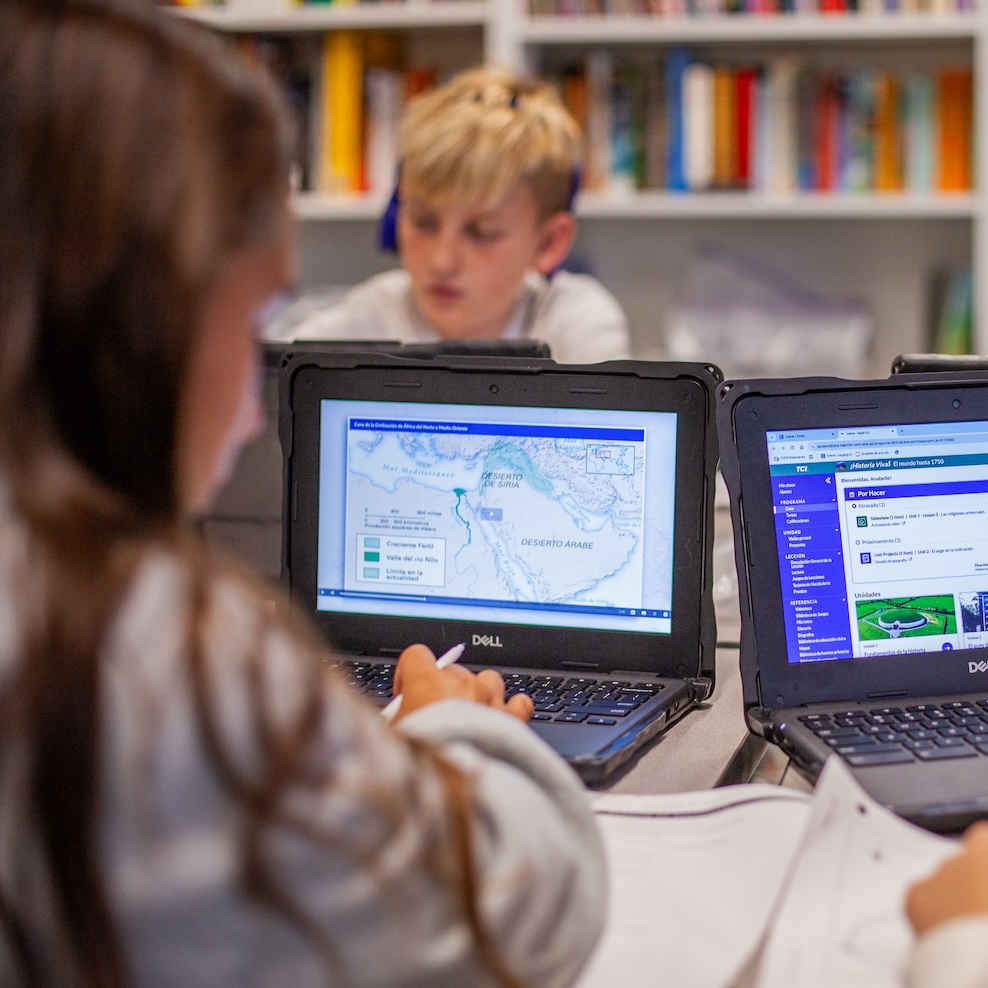 students working on geography project on computers