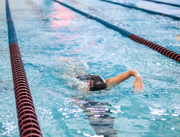 swimmer racing in a lane in a pool