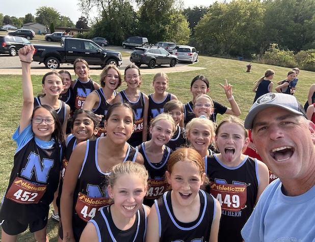 coach taking selfie with his girls cross country team