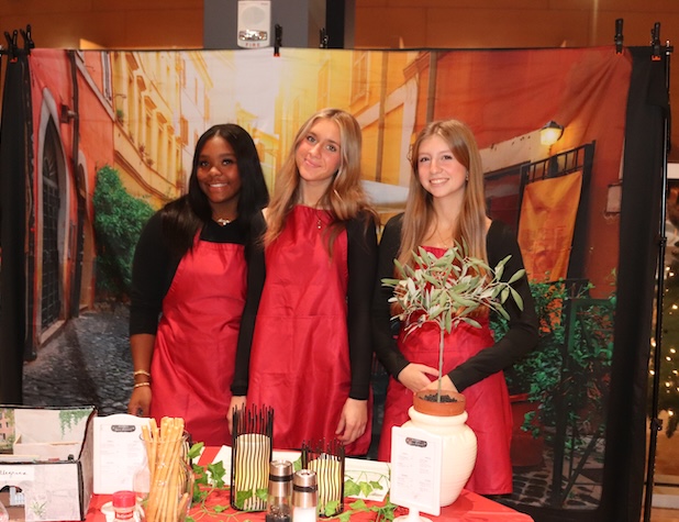 three female students working at a restaurant they created