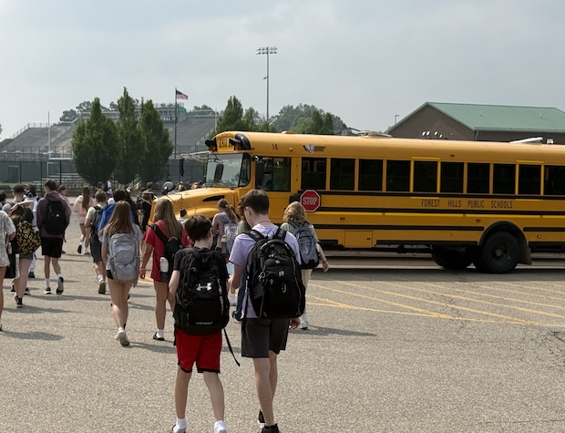 high school students walking to school bus