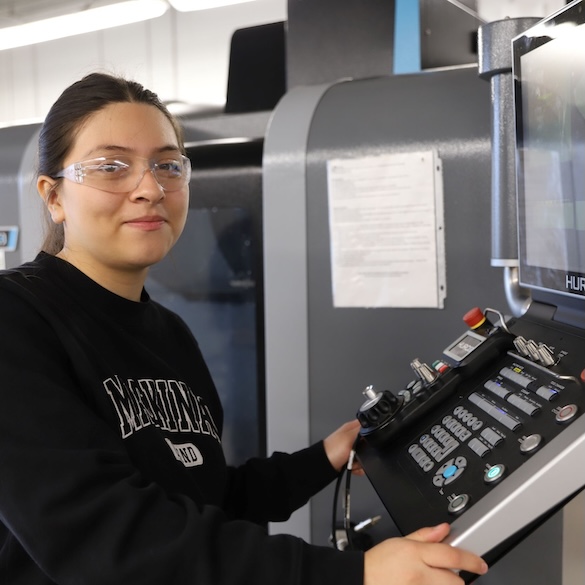 female student working with a cnc machine