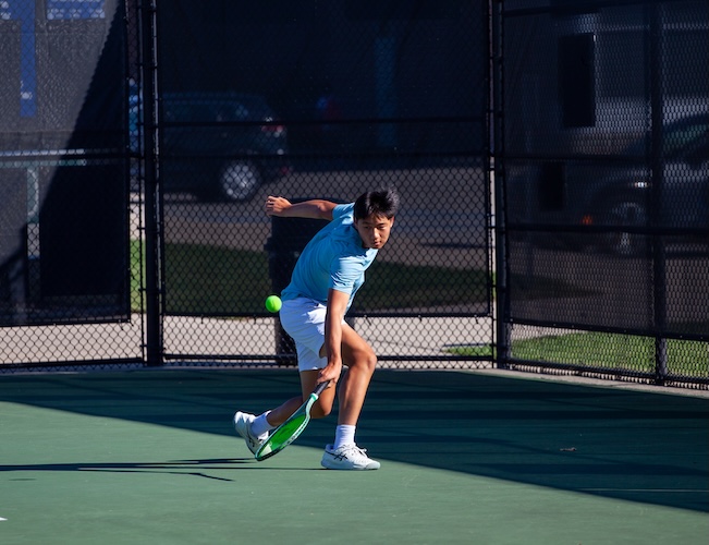 tennis player hitting a tennis ball