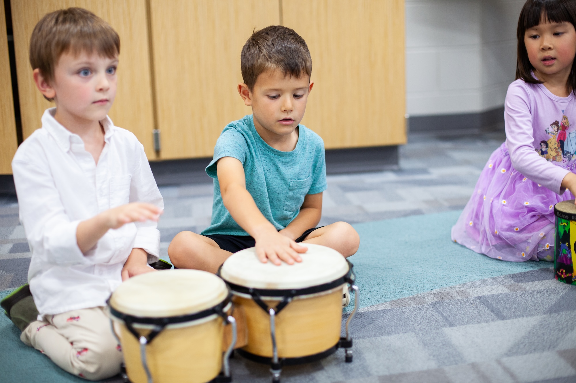 young students playing bongos/drums in class