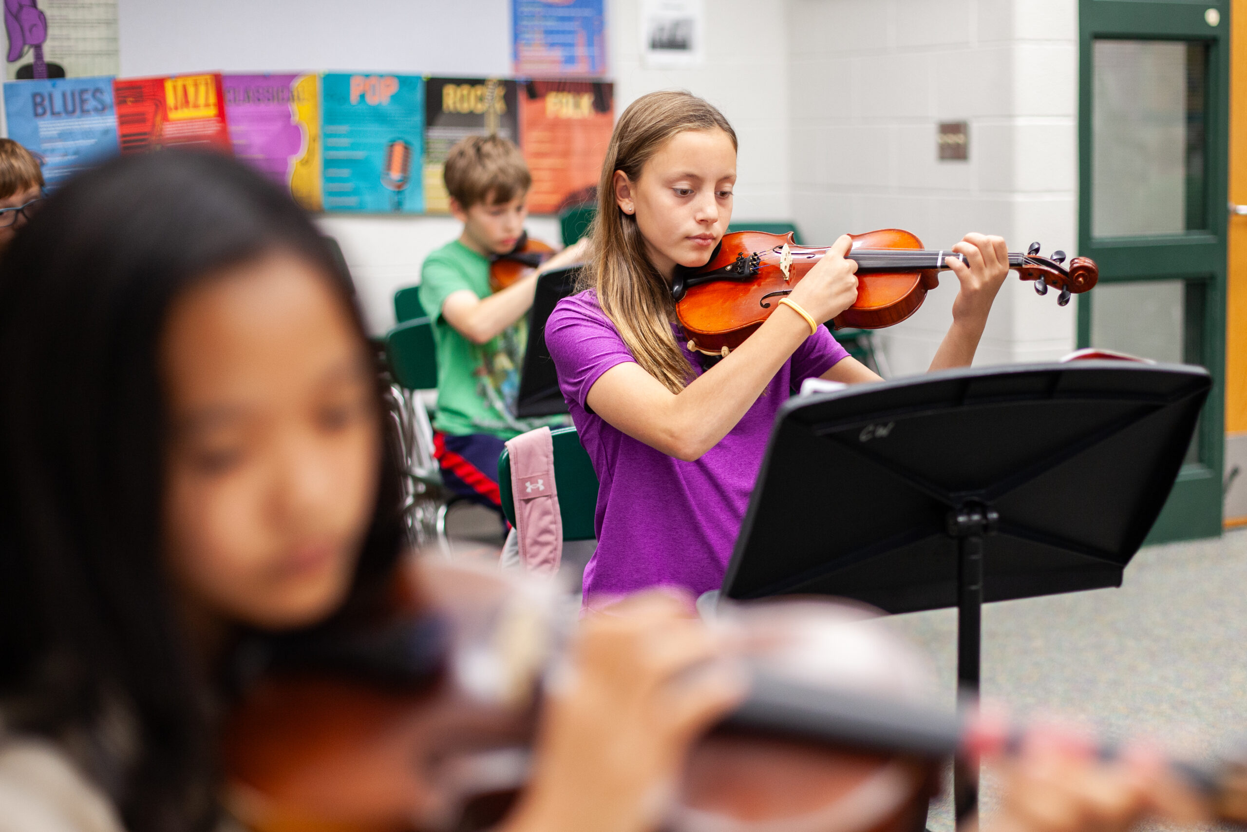 young students practicing their instruments in class