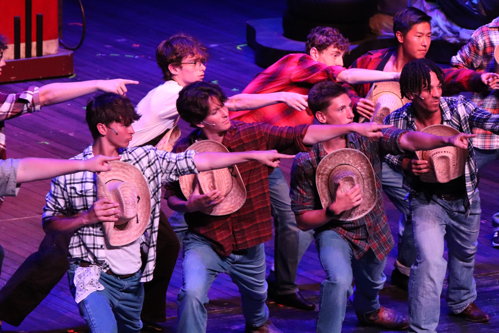 students performing a musical on stage at the fine arts center