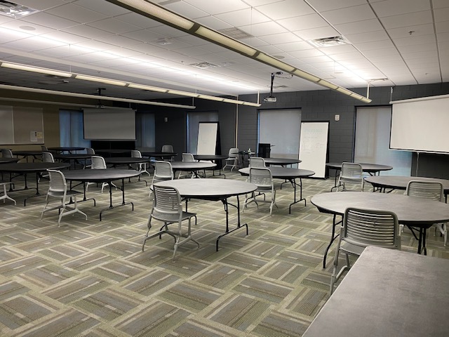 fine arts center room with tables and chairs