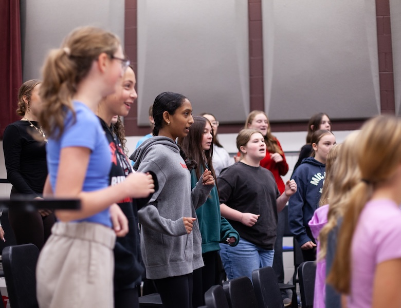 middle school choir team practicing in class
