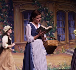 female student playing a role on stage in the fine arts center