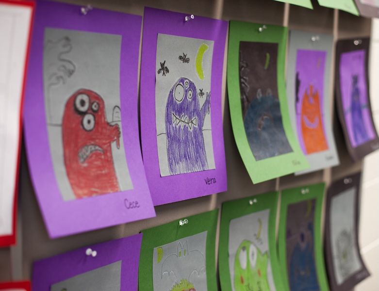 student-made art of monsters hanging in the hallways