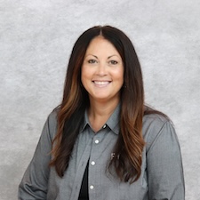 Woman in gray smiling