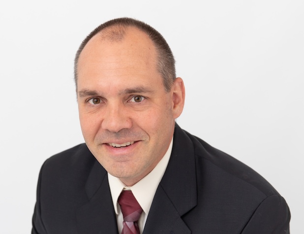 Man smiling for a headshot
